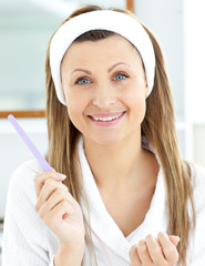 Canvas Print - Positive woman filling her nails in the bathroom