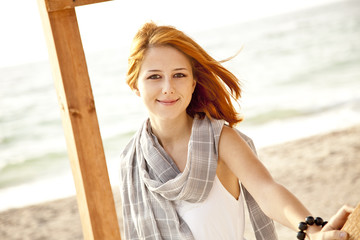 Sticker - Young red-haired girl at wood near sea.