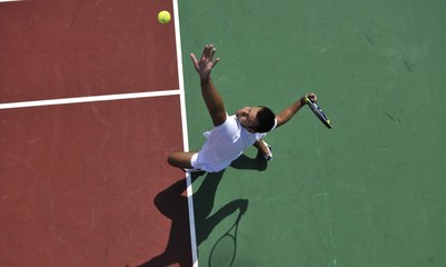 young man play tennis outdoor