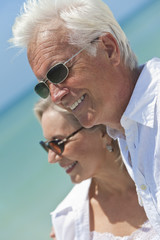 Wall Mural - Happy Senior Couple Looking To Sea on A Tropical Beach