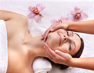 Young woman on massage table in beauty spa.