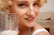 beautiful blond woman with a glass of milk