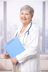 Senior doctor holding notepad