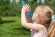 © Michail Pavlov - A little girl is drinking clean water from a bottle