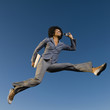© Erik Isakson/Blend Images - African businesswoman talking on cell phone in mid-air
