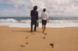 © PBNJ Productions/Blend Images - Businessman and businesswoman walking towards ocean