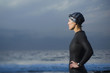 © Erik Isakson/Blend Images - Hispanic woman in wetsuit on beach
