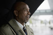© Mark Edward Atkinson/Blend Images - African businessman holding umbrella