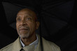 © Mark Edward Atkinson/Blend Images - African businessman holding umbrella