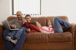 © CRG STUDIOS/Blend Images - Antiguan man using laptop in living room with family