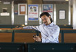 © Granger Wootz/Blend Images - Mixed race man looking down at cell phone