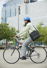 Mixed Race Man Riding Bicycle In City