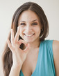 © JGI/Jamie Grill/Blend Images - Mixed race woman making ok symbol