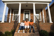 © Roberto Westbrook/Blend Images - 'African mother, daughter and son sitting on front stoop of house'