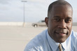 © Mark Edward Atkinson/Blend Images - African businessman standing in parking lot