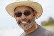 © Rolf Bruderer/Blend Images - African man in straw hat smiling