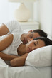 © JGI/Jamie Grill/Blend Images - Hispanic couple sleeping in bed
