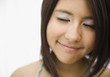 © Frida Marquez/Blend Images - Hispanic teenage girl smiling with eyes closed