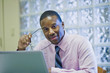 © Steve Prezant/Blend Images - African American businessman sitting at desk