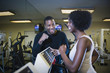 © Steve Prezant/Blend Images - Personal trainer motivating woman on treadmill
