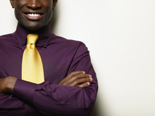 Smiling Black Businessman With Arms Crossed