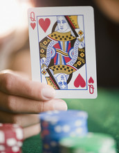 Hand Holding Queen Of Hearts Playing Card