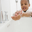 © JGI/Jamie Grill/Blend Images - African American boy washing hands