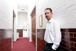White Shirt Man in Tiled Corridor