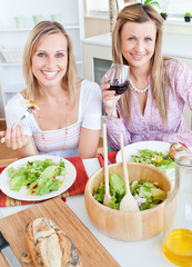 Poster - Two positive female friends eating salad in the kitchen