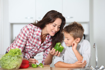 Wall Mural - Mother cooking with son in kitchen