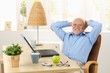 © nyul - Happy elderly man smiling at desk