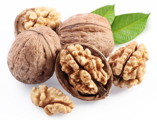 Wall Mural - Walnuts with leaf isolated on a white background.