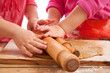 © Elena Moiseeva - two little girls with rolling pins baking and having fun