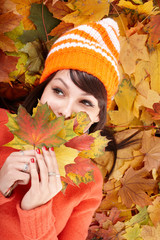 Wall Mural - young woman in autumn orange leaves.