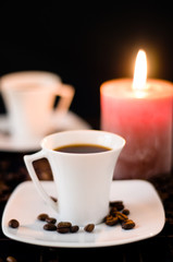 Cup of the coffee on the black background. Close up.