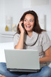 © goodluz - Woman on sofa with laptop computer