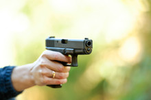 Woman Aiming A Handgun