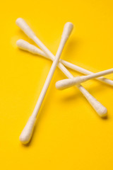 Wall Mural - Cotton swabs isolated on yellow background