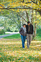 Romantic young beautiful couple on autumn walk