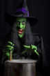 Scary witch stirring a smoking cauldron.