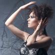 © Acronym - Fashion photo of a young brunette on a mystique background