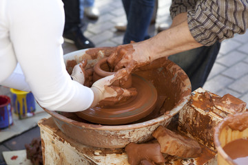 Potter teaches cooking pots his assistant.