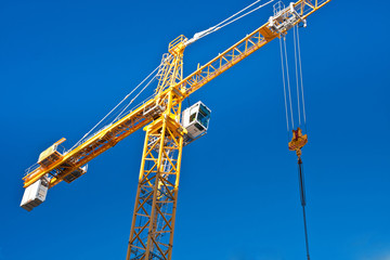 Yellow crane against blue sky