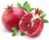 Fototapeta  - Juicy pomegranate and its half with leaves.