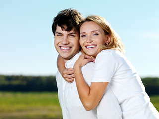 Wall Mural - happy laughing beautiful couple posing on nature