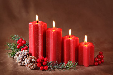 Wall Mural - Red christmas candles on brown background