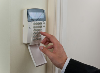businessman entering security code to pass