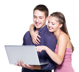 Young beautiful smiling couple looking at laptop