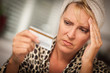 Upset Woman Holding Her Credit Card