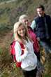 © goodluz - Parents and daughter walking in the countryside